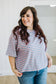 Woman wearing a striped shirt and jeans indoors